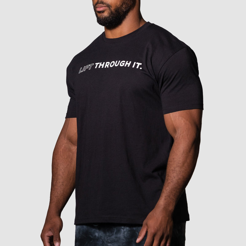 Load image into Gallery viewer, Person wearing a black t-shirt with 'LIFT THROUGH IT.' text on a plain background