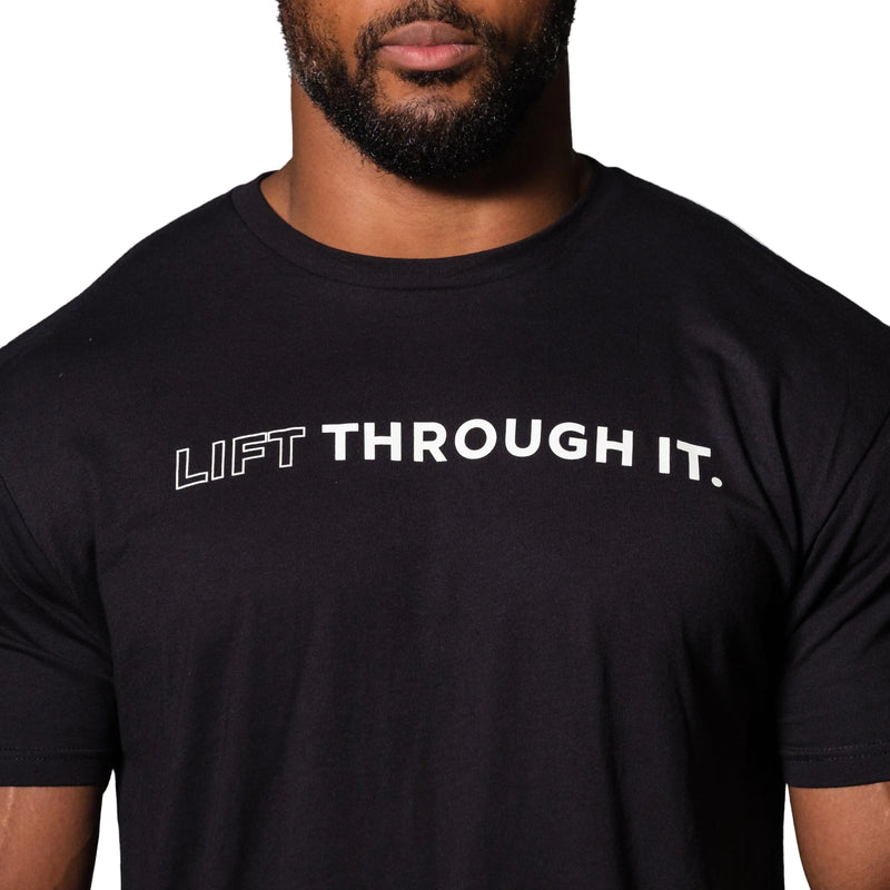 Load image into Gallery viewer, Person wearing a black t-shirt with 'LIFT THROUGH IT.' text on a plain background