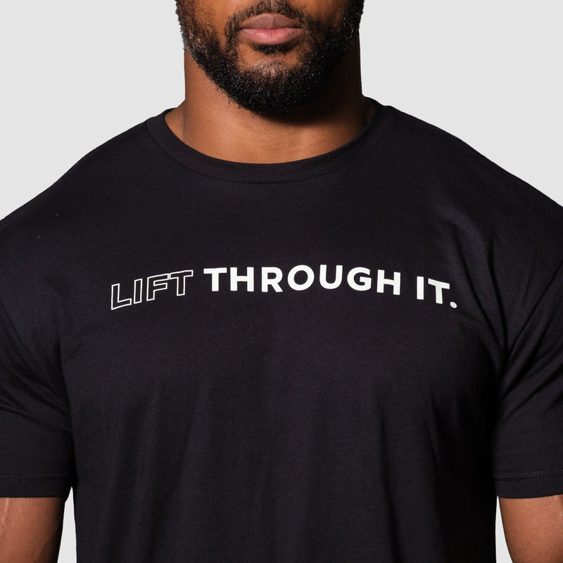 Load image into Gallery viewer, Person wearing a black t-shirt with 'LIFT THROUGH IT.' text on a plain background