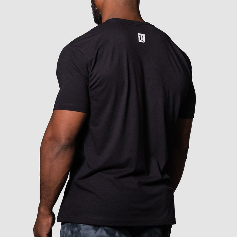 Load image into Gallery viewer, Person wearing a black t-shirt with a logo on the back against a gray background