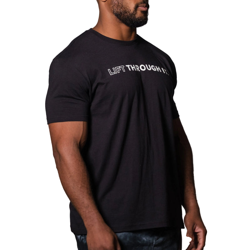 Load image into Gallery viewer, A person wearing a black crew neck t-shirt with the text 'Lift Through It' printed on the front.