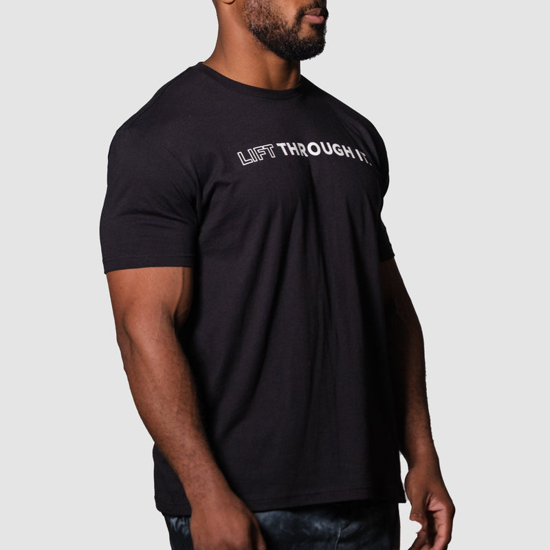 Load image into Gallery viewer, A person wearing a black crew neck t-shirt with the text 'Lift Through It' printed on the front.