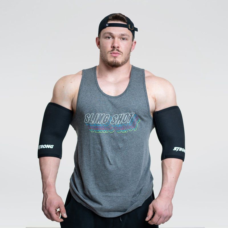 Load image into Gallery viewer, A person wearing gray elbow sleeves with the brand name 'STrong' on them.