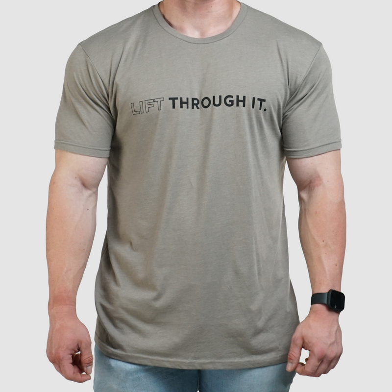 Load image into Gallery viewer, A person wearing a black crew neck t-shirt with the text 'Lift Through It' printed on the front.
