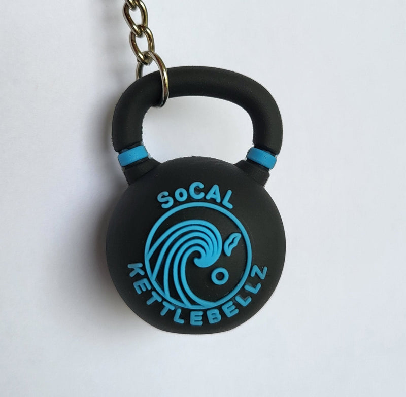 Load image into Gallery viewer, Black and blue kettlebell-shaped keychain on a white background