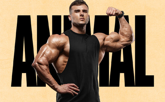 male bodybuilder flexing in front of a black and tan ANIMAL logo