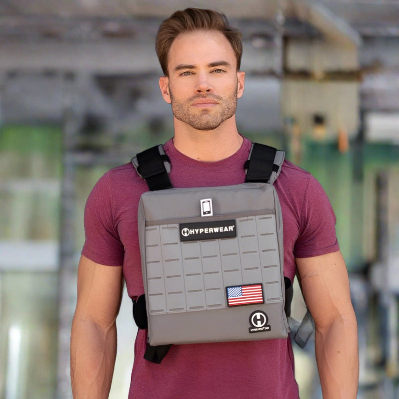 Load image into Gallery viewer, Picture of a male CrossFit athlete standing in a CrossFit box wearing a heavy weight vest
