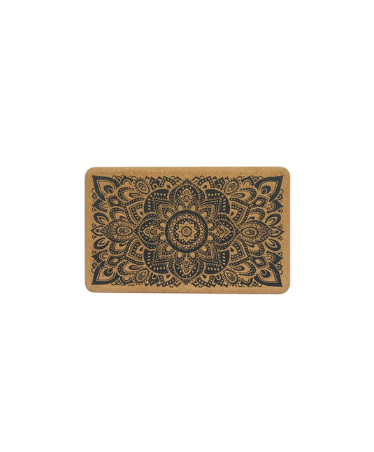 A cork yoga block with a decorative pattern on the top surface.